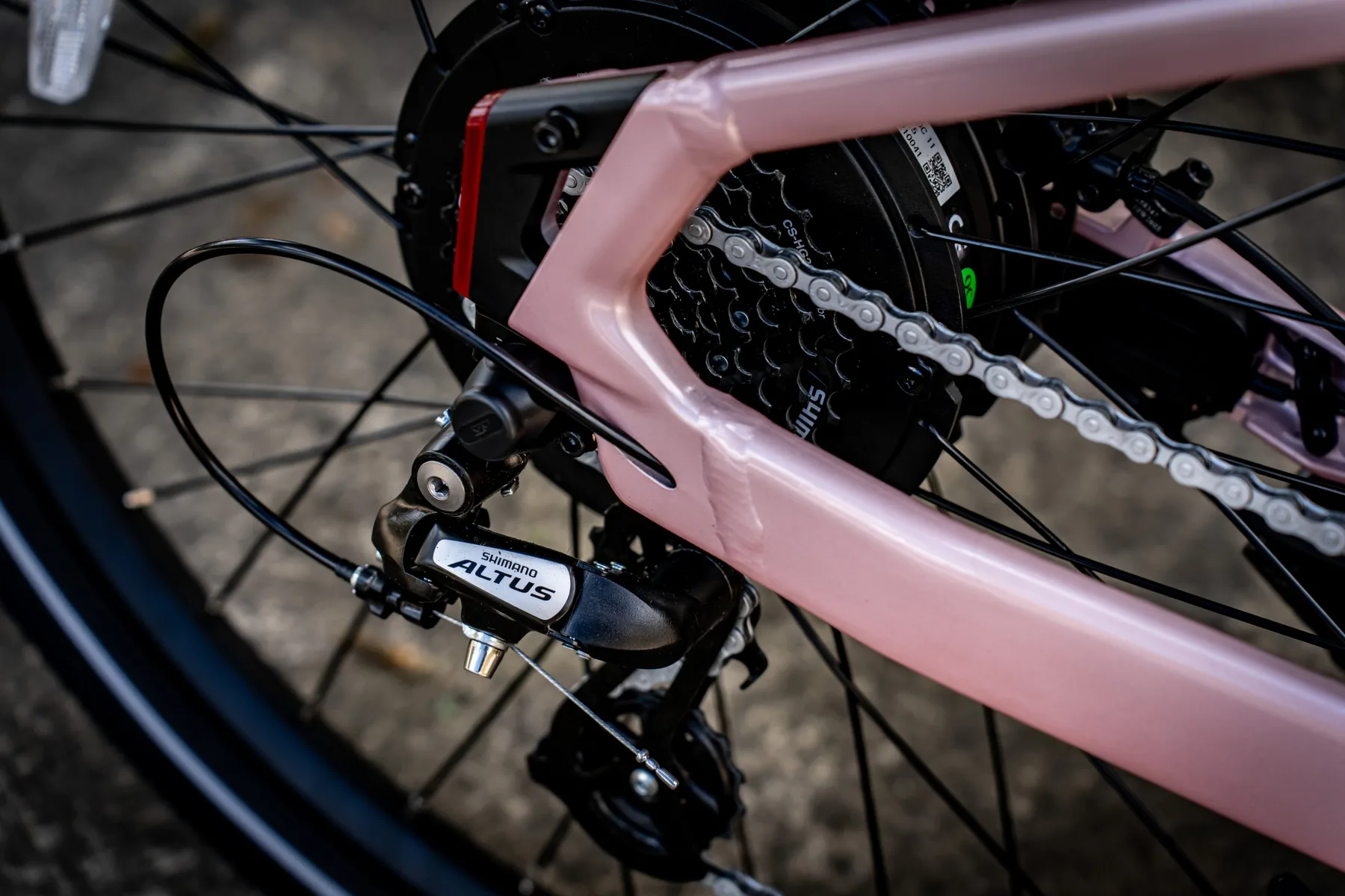 Shimano Altus rear derailleur and the rear hub motor on the pink Aventon Pace 5 REC ST