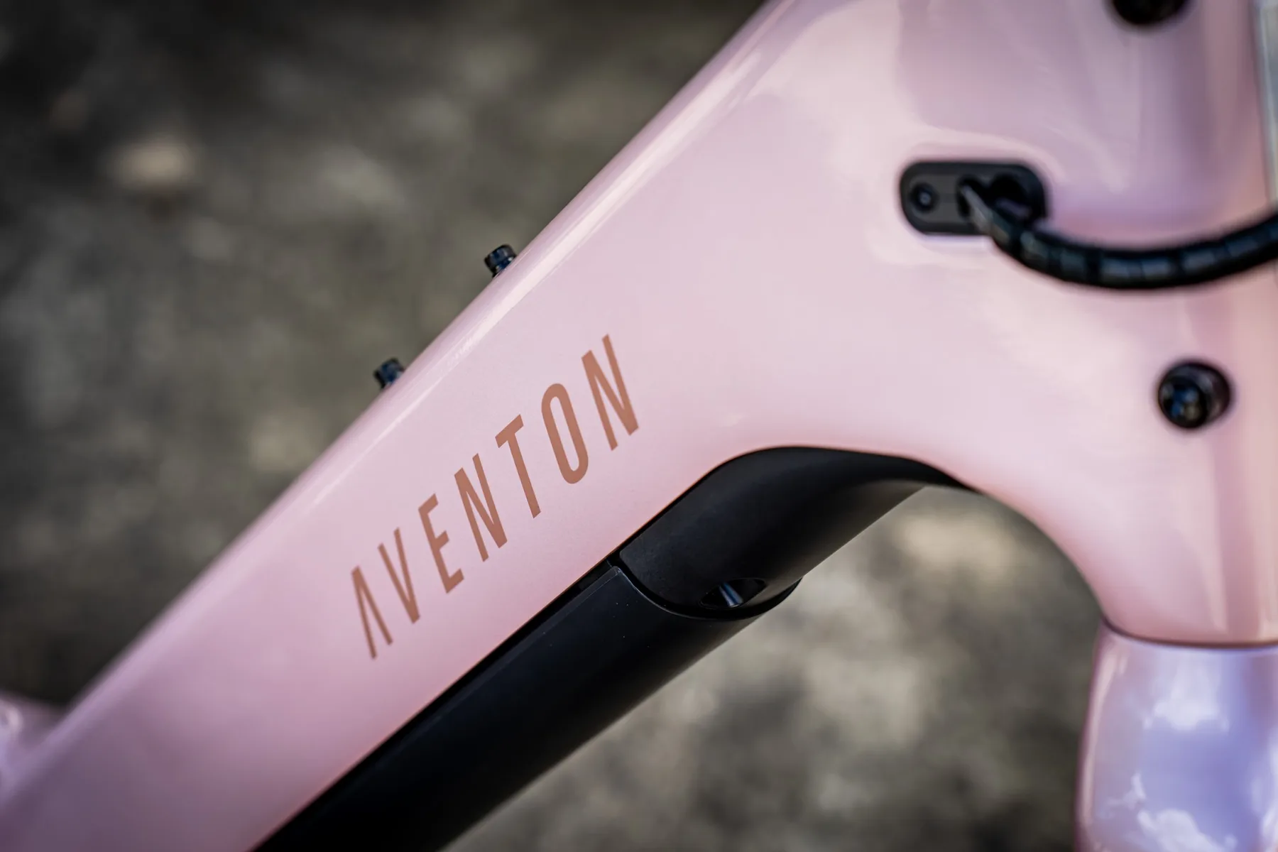 Close-up of the Aventon logo on the pink down tube of the Pace 5 REC ST